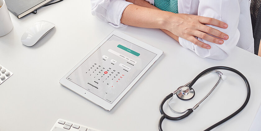 High angle shot of a female doctor consulting the calendar on her tablet