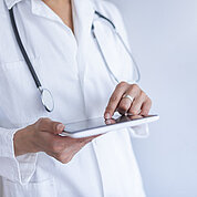 Portrait of female doctor using her digital tablet in the office.