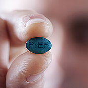 young man with a PrEP pill